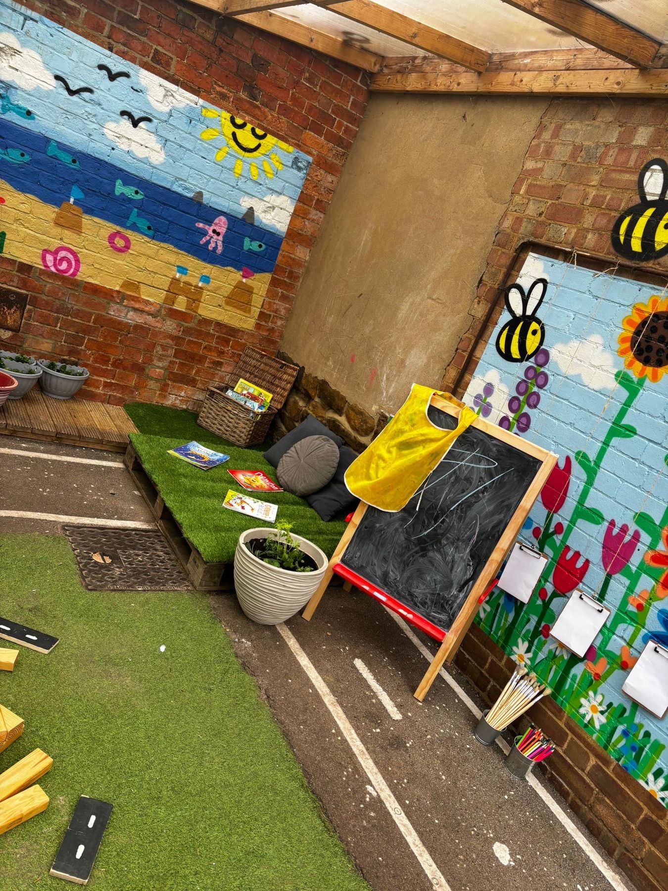 Painted bee and flower mural in the covered outdoor area