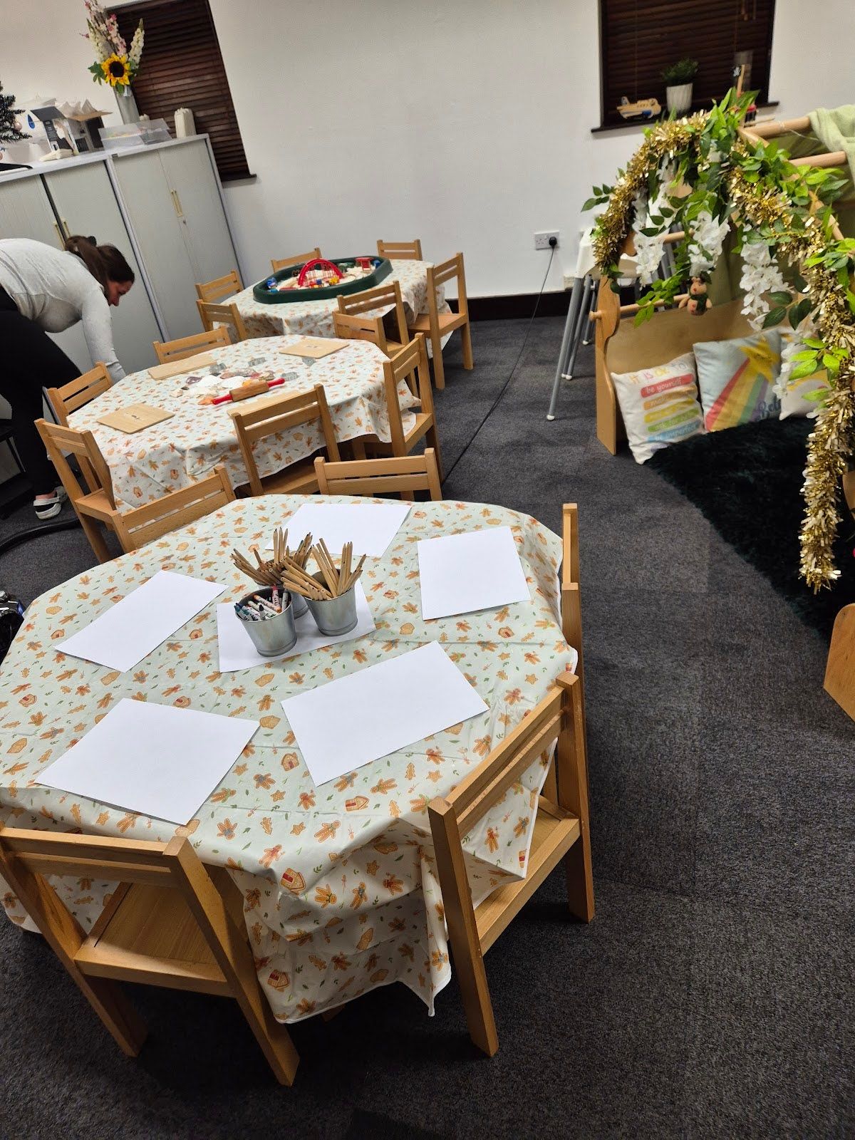 Craft tables set out with paper and mark-making pots