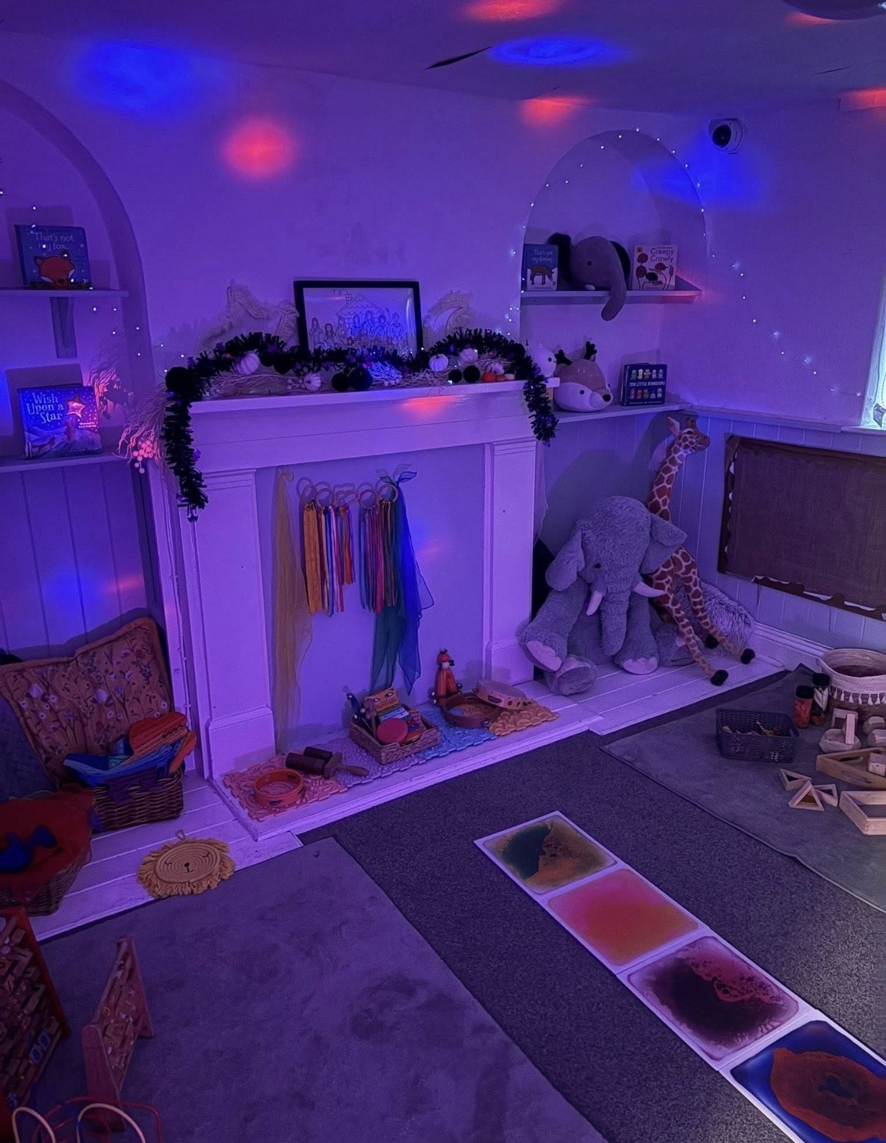 The sensory room lit in colour-changing light