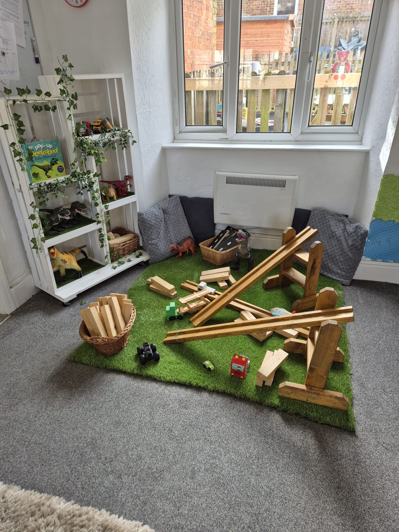 Wooden block construction area on the Toddler Room grass mat