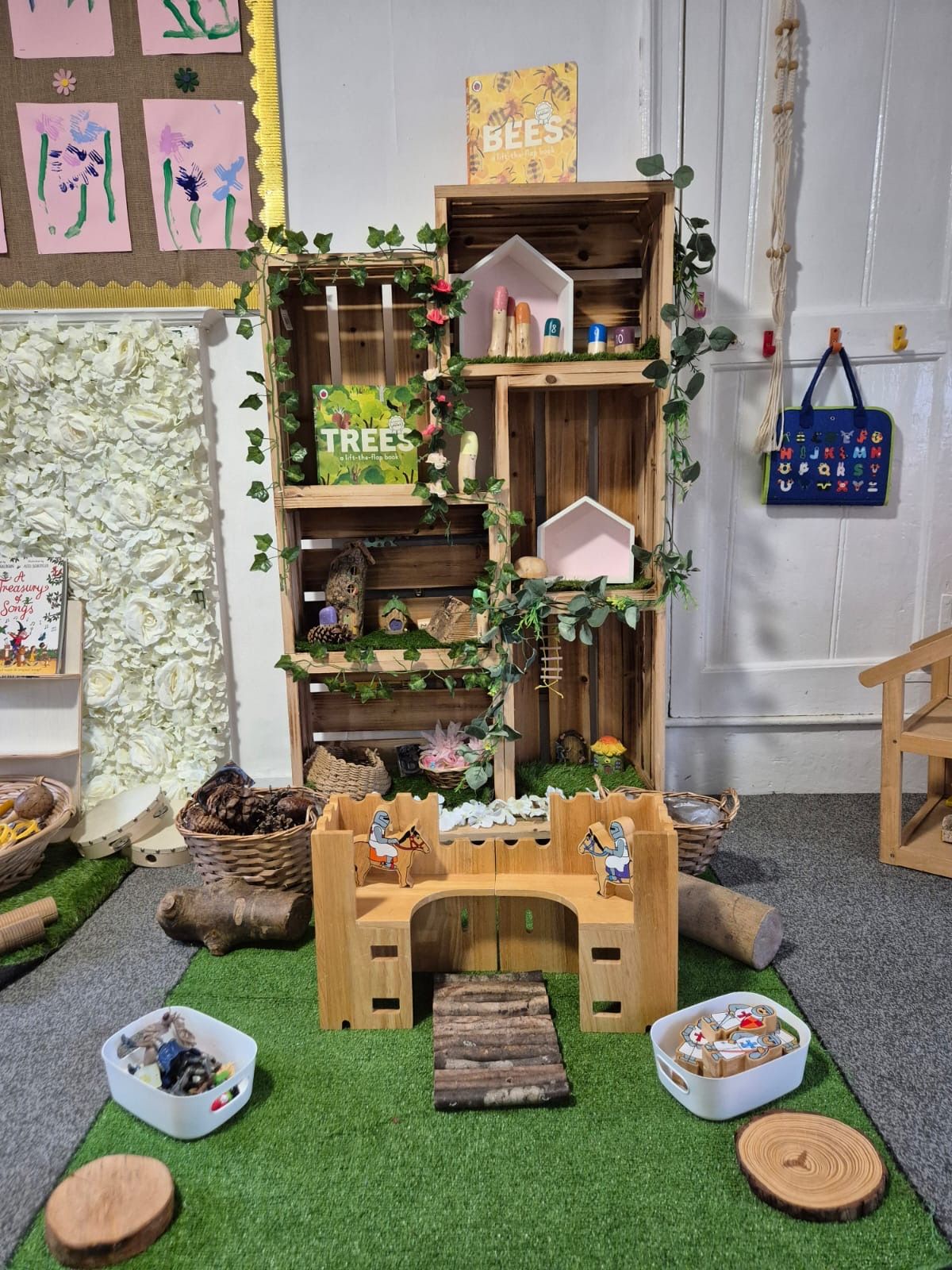 Nature exploration area with logs and wooden house